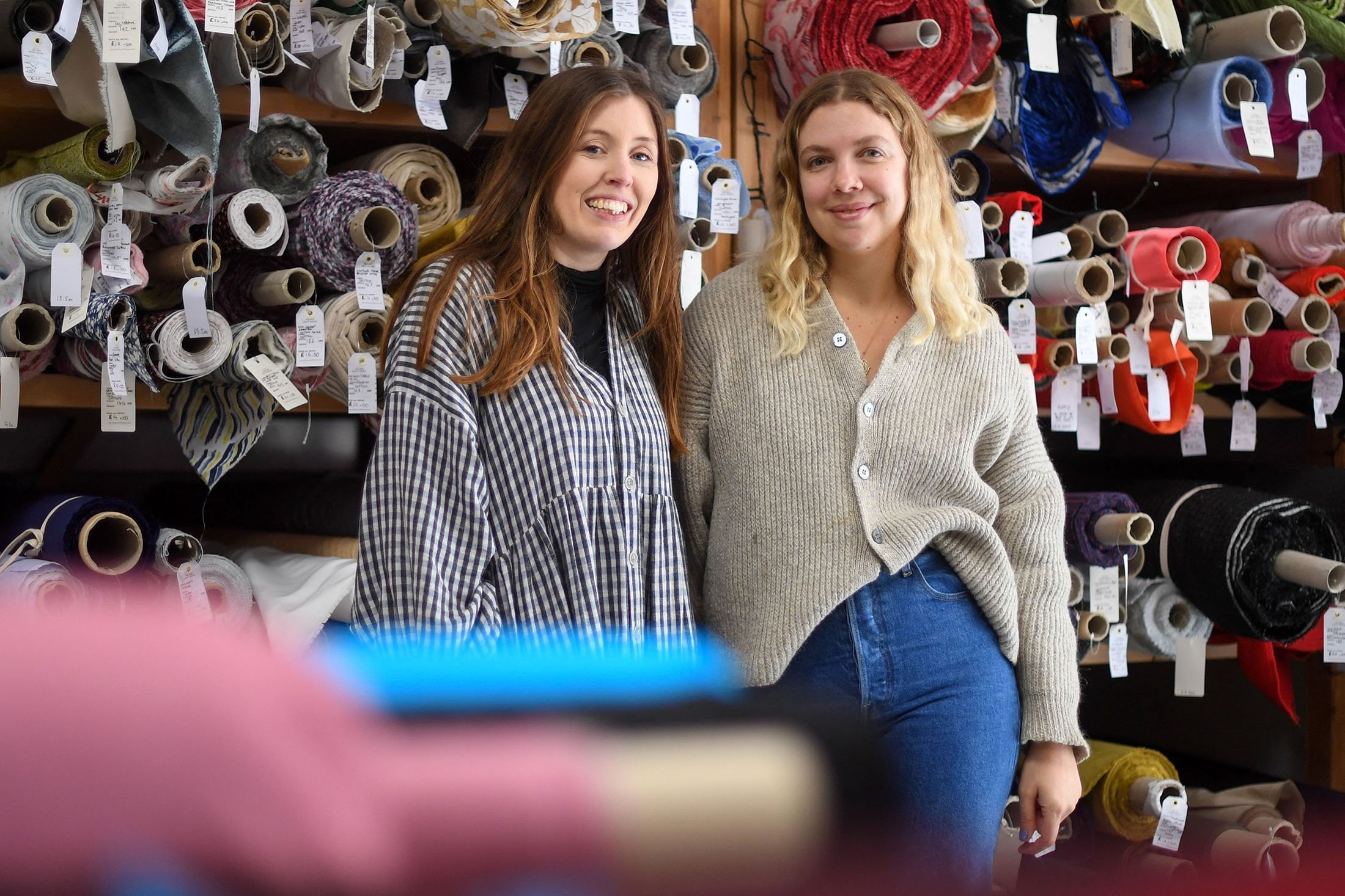 Rosie Scott (L) and Hannah Silvani, co-founders of The New Craft House, a sewing workshop studio and designer deadstock fabric shop, in Hackney, East London, U.K., Feb. 11, 2022. (AFP Photo)