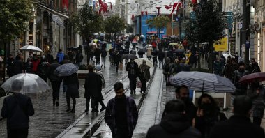 People walk in the rain in Istanbul, Turkey, Feb. 3, 2022. (AP Photo)
