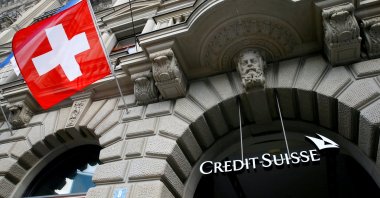 Switzerland&#039;s national flag flies below a logo of Swiss bank Credit Suisse at its headquarters at the Paradeplatz Square in Zurich, Switzerland, July 31, 2019. (Reuters Photo)