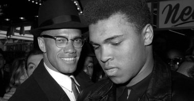 World heavyweight boxing champion Muhammad Ali (R) poses with the black Muslim leader Malcolm X, outside the Trans-Lux Newsreel Theater after watching a screening of films on Ali's title fight with Sonny Liston in Miami Beach, New York City, U.S., March 1, 1964. (AP Photo)