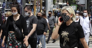People wearing face masks to protect against the spread of the coronavirus walk in the city&#039;s main Kızılay Square, Ankara, Turkey, June 16, 2020. (AP Photo)