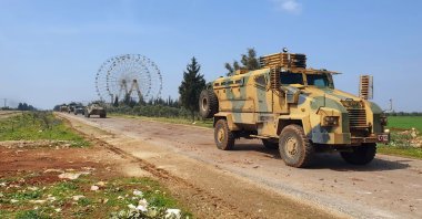 Turkish and Russian troops patrol on the M4 highway, which runs east-west through Idlib province, Syria, March 15, 2020. (AP Photo)