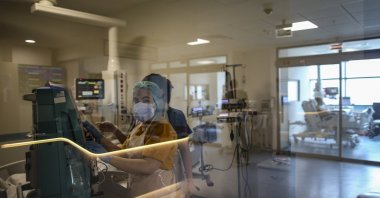 Medical personnel tend to a patient infected with COVID-19 at the intensive care unit of the Cemil Tascıoğlu City Hospital in Istanbul, Turkey, Friday, April 9, 2021. (AP Photo)