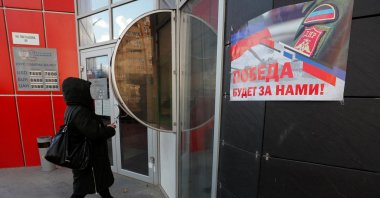 A woman approaches an ATM money machine in the separatist-controlled city of Donetsk, Ukraine, Feb. 21, 2022. (Reuters Photo)