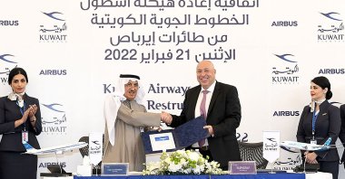 A photo provided by the Kuwaiti news agency KUNA shows the Chairperson of Kuwait Airways Ali Al-Dakhnan (C-L) shaking hands with Mikail Houari, President of Airbus Africa and the Middle East, after signing a deal at the Kuwait airways headquarters, Kuwait, Feb. 21, 2022. (AFP Photo)