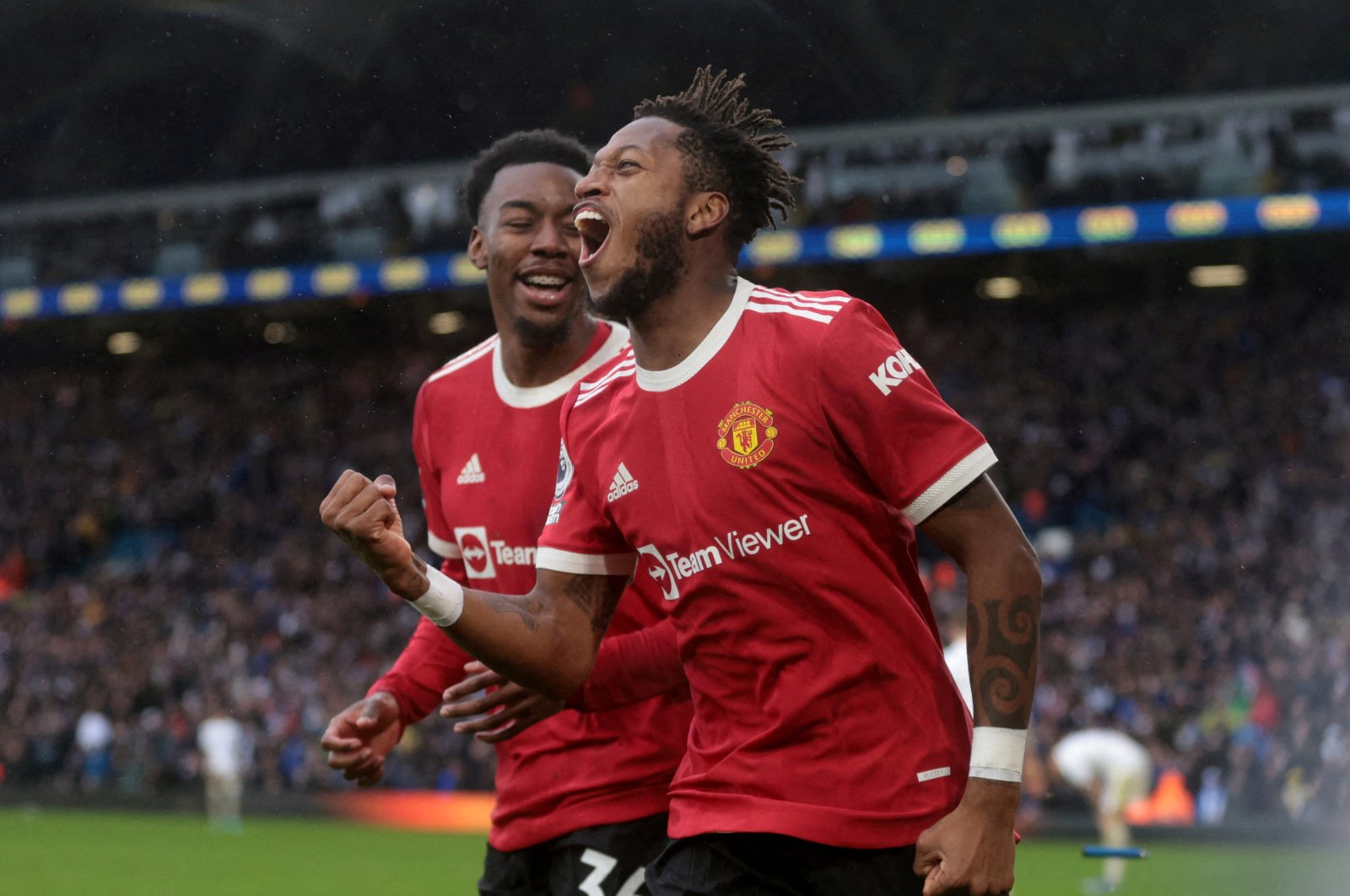 Manchester United&#039;s Fred (L) celebrates with Anthony Elanga after scoring in a Premier League match against Leeds United, Leeds, England, Feb. 20, 2022. (Reuters Photo)