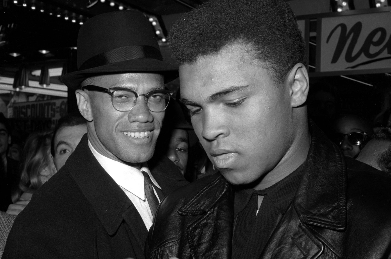 World heavyweight boxing champion Muhammad Ali (R) poses with the black Muslim leader Malcolm X, outside the Trans-Lux Newsreel Theater after watching a screening of films on Ali&#039;s title fight with Sonny Liston in Miami Beach, New York City, U.S., March 1, 1964. (AP Photo)