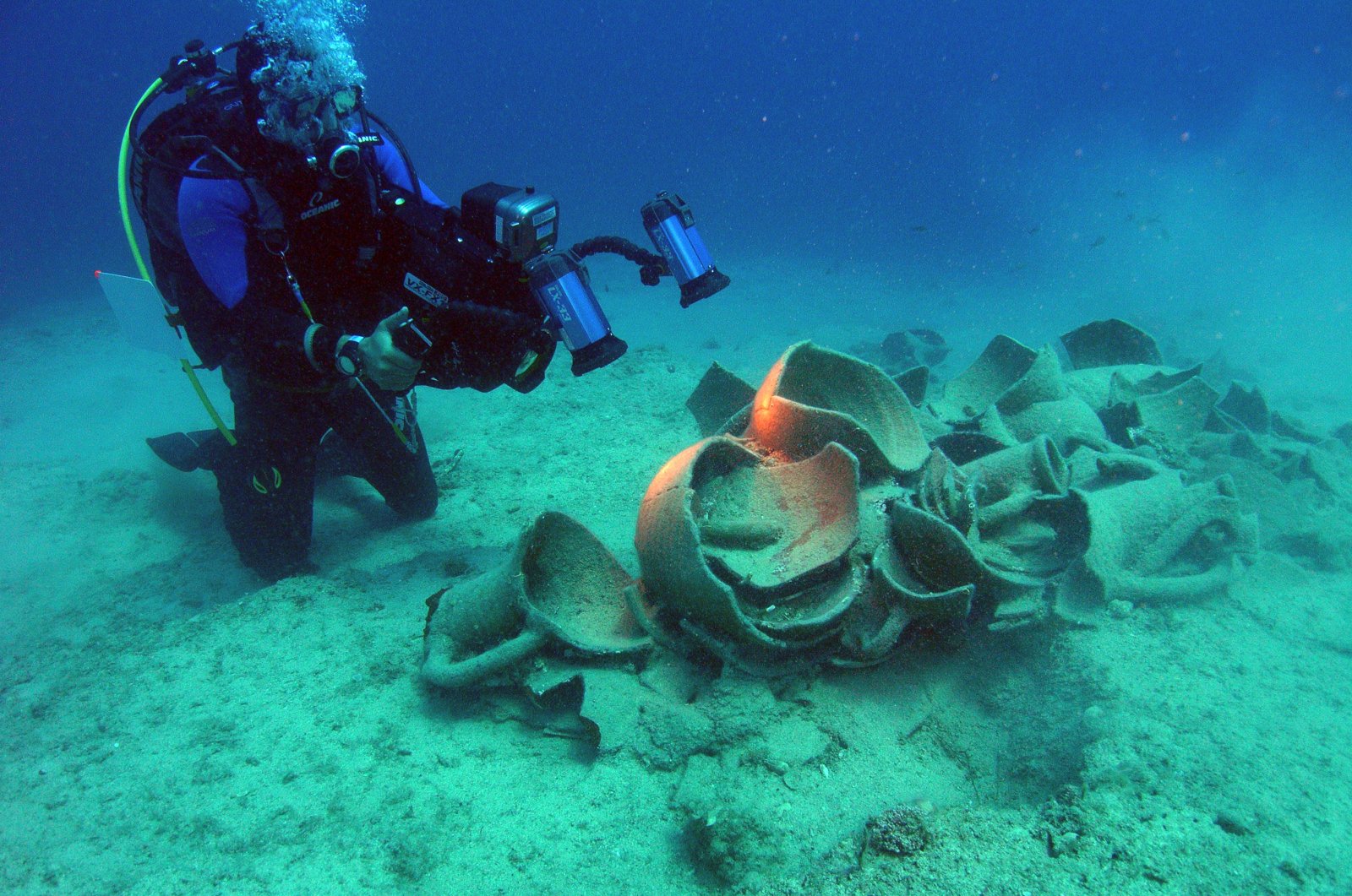 A researcher records amphorae found in the Rhodes shipwreck in the Gulf of Fethiye, southwestern Turkey, Feb. 20, 2022. (AA Photo)