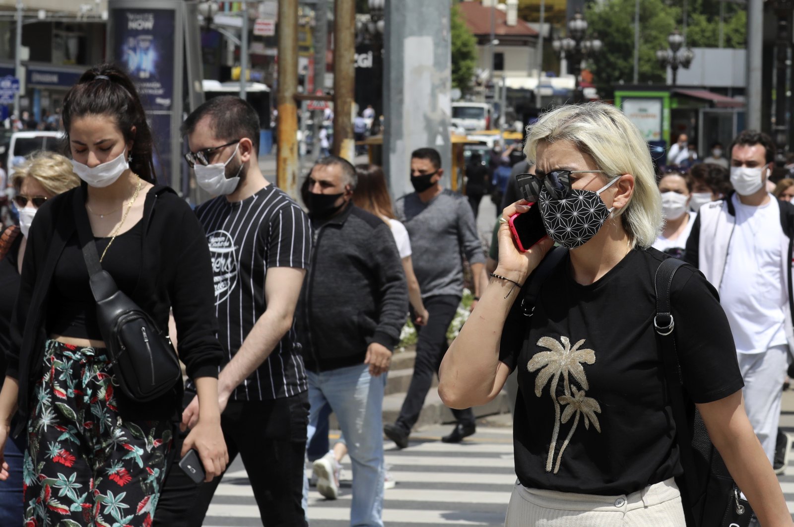 People wearing face masks to protect against the spread of the coronavirus walk in the city&#039;s main Kızılay Square, Ankara, Turkey, June 16, 2020. (AP Photo)