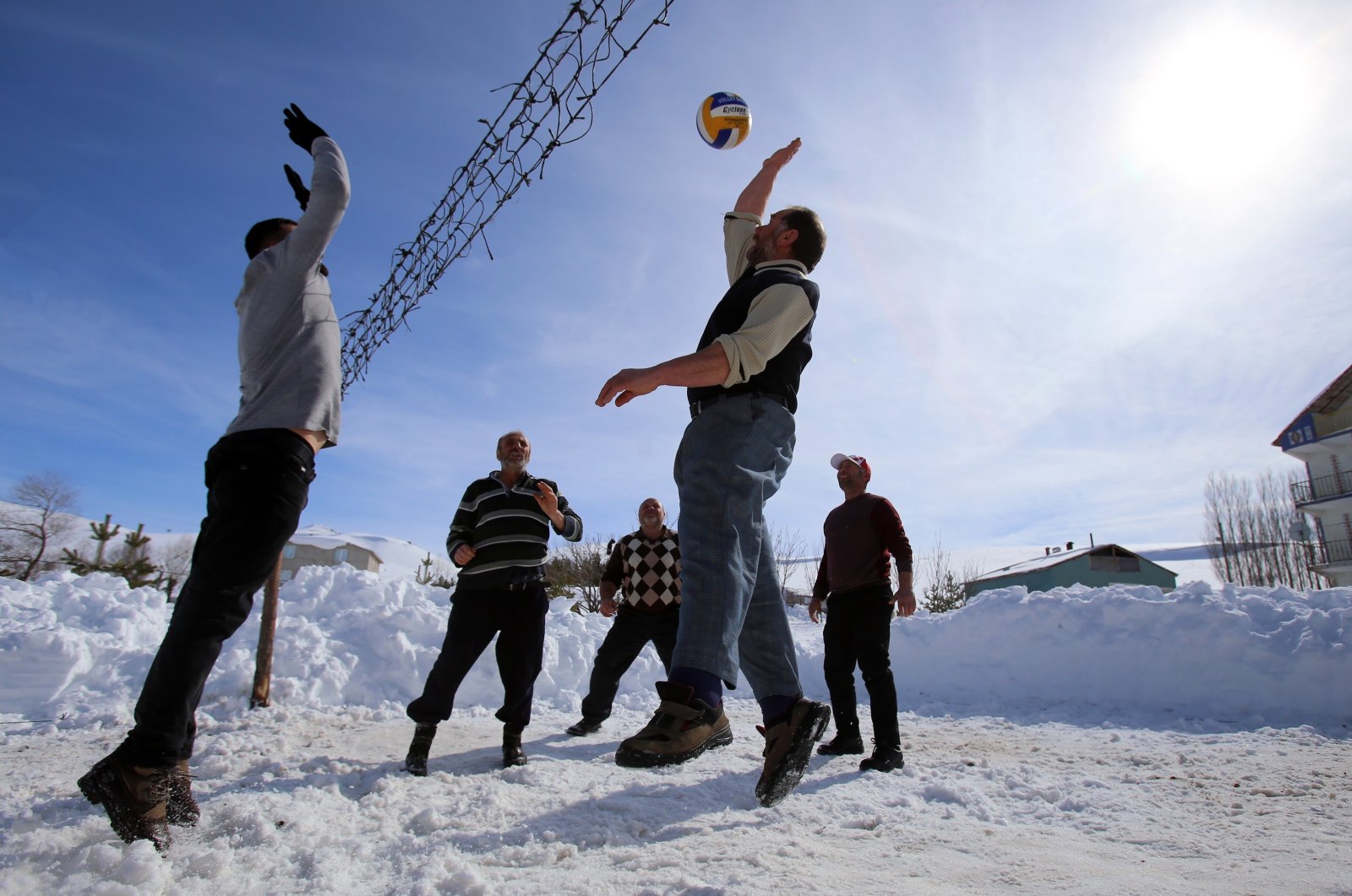 Locals from the village of Yenice play snow volleyball, Gümüşhane, northeastern Turkey, Feb. 21, 2022. (IHA Photo)