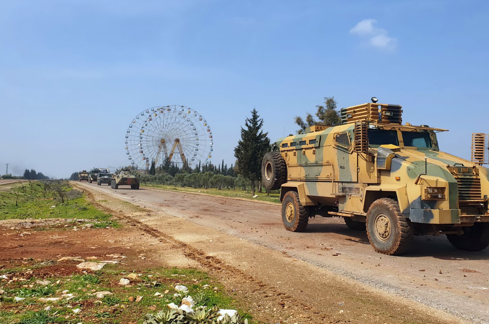 Turkish and Russian troops patrol on the M4 highway, which runs east-west through Idlib province, Syria, March 15, 2020. (AP Photo)
