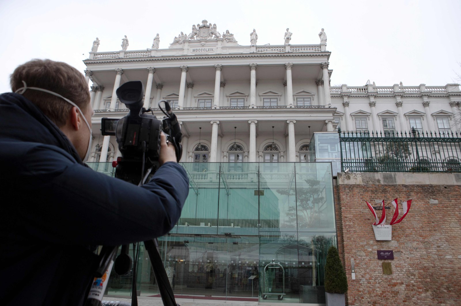 A cameraperson films the Hotel Palais Coburg in Vienna, venue of diplomatic talks on Iran&#039;s nuclear program, Feb. 8, 2022. (AFP Photo)