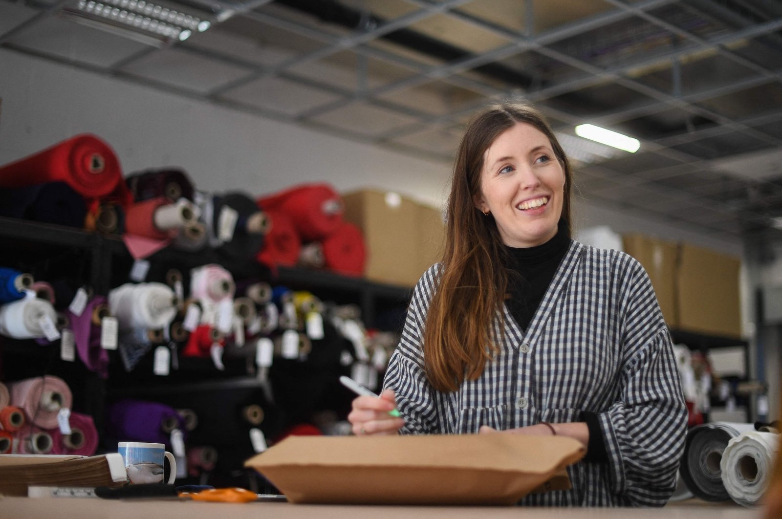 Rosie Scott, co-founder of The New Craft House, a sewing workshop studio and designer deadstock fabric shop, in Hackney, East London, U.K., Feb. 11, 2022. (AFP Photo)