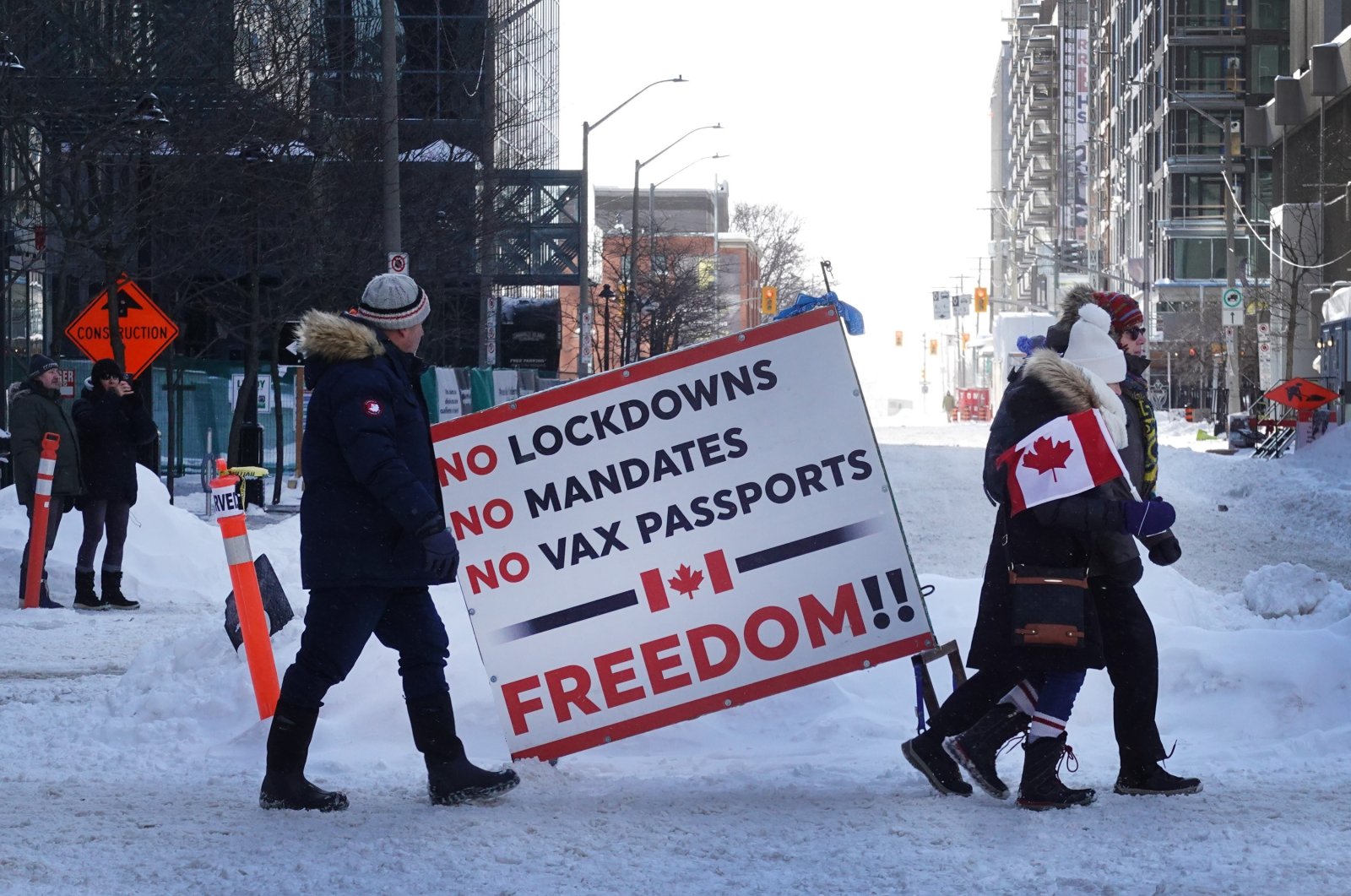 People walk toward Parliament Hill where earlier in the day police moved in and ended a demonstration organized by truck drivers opposing vaccine mandates that had been entrenched for the past 23 days in Ottawa, Ontario, Canada, Feb. 19, 2022. (AFP Photo)