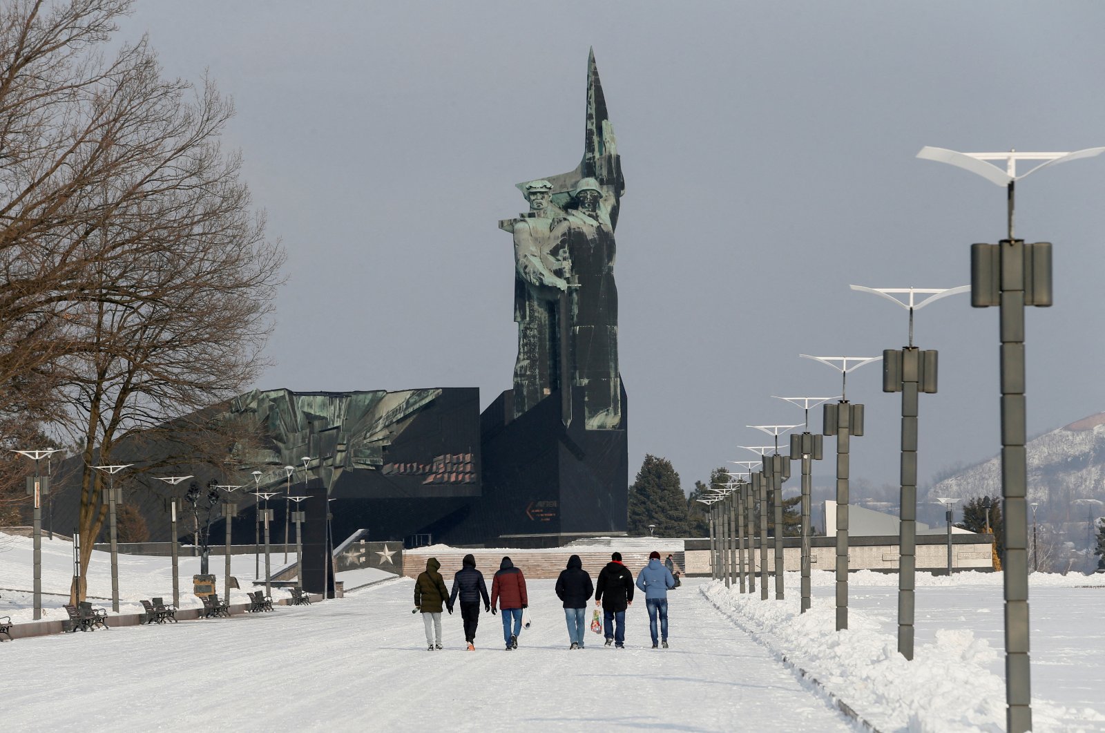 People walk towards a monument to the Liberators of Donbass in the rebel-held city of Donetsk, Ukraine, Jan. 27, 2022. (Reuters File Photo)
