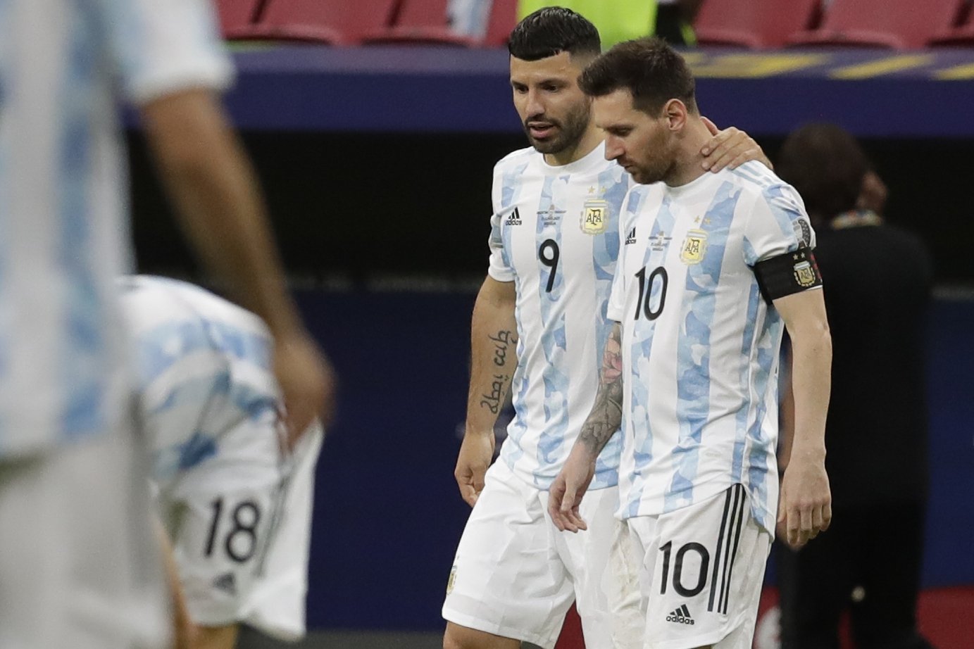 Argentina&#039;s Sergio Aguero (C) embraces teammate Lionel Messi during a Copa America match against Paraguay, Brasilia, Brazil, June 21, 2021. (AP Photo)