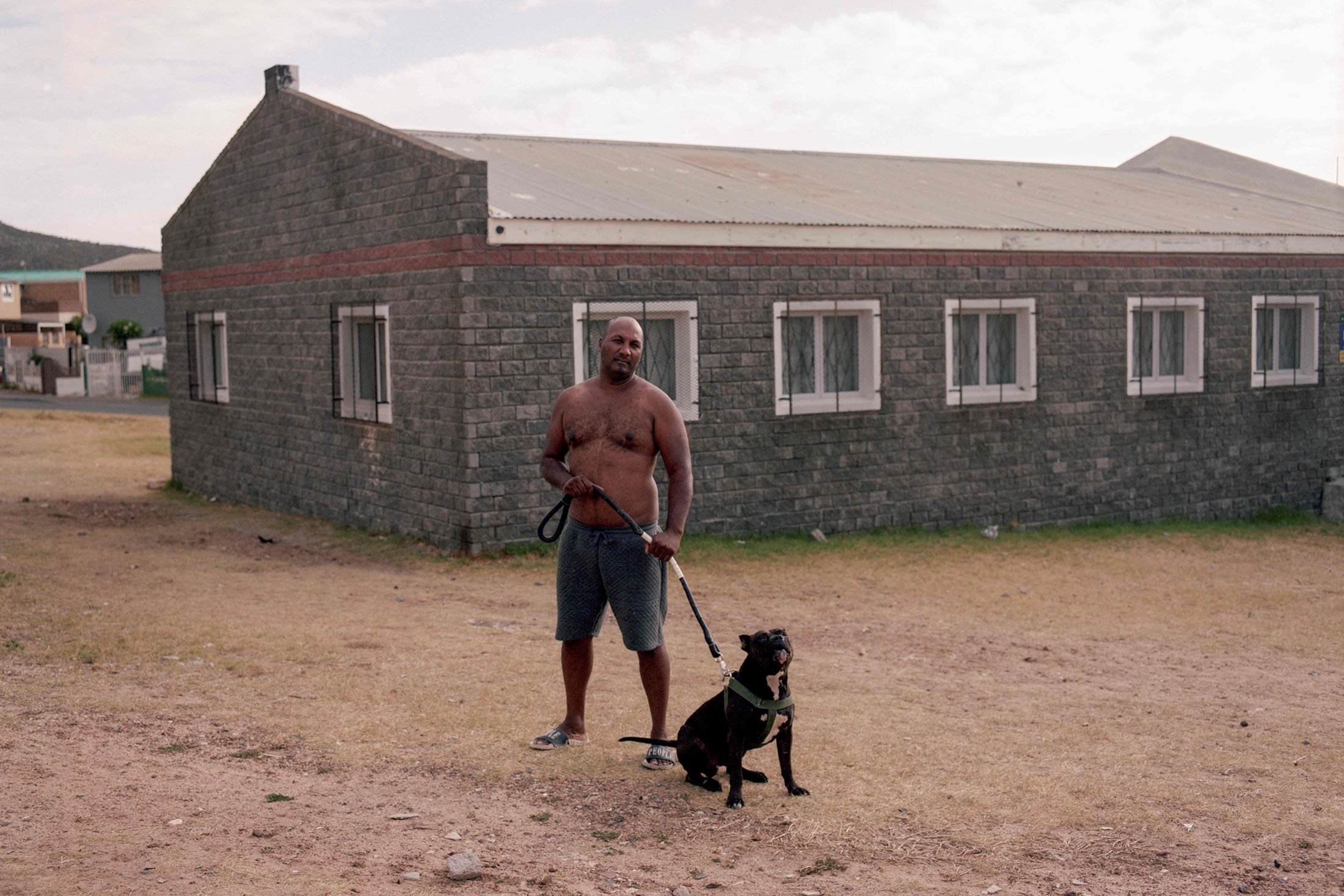 A man stands with his dog in Ocean View, Cape Town, South Africa, Feb. 3, 2022. (AFP Photo)