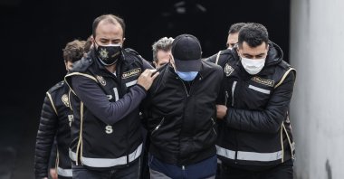 Police officers accompany detained suspects in tthe Halil Falyalı murder case for a court hearing in Istanbul, Feb. 22, 2022. (AA Photo)