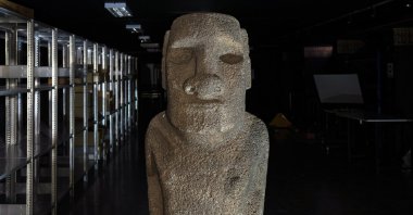 A Moai Tau statue sits inside the Natural History Museum during a ceremony in Santiago, Chile, before it is returned to Chile's Easter Island, Feb. 21, 2022. (AP Photo)