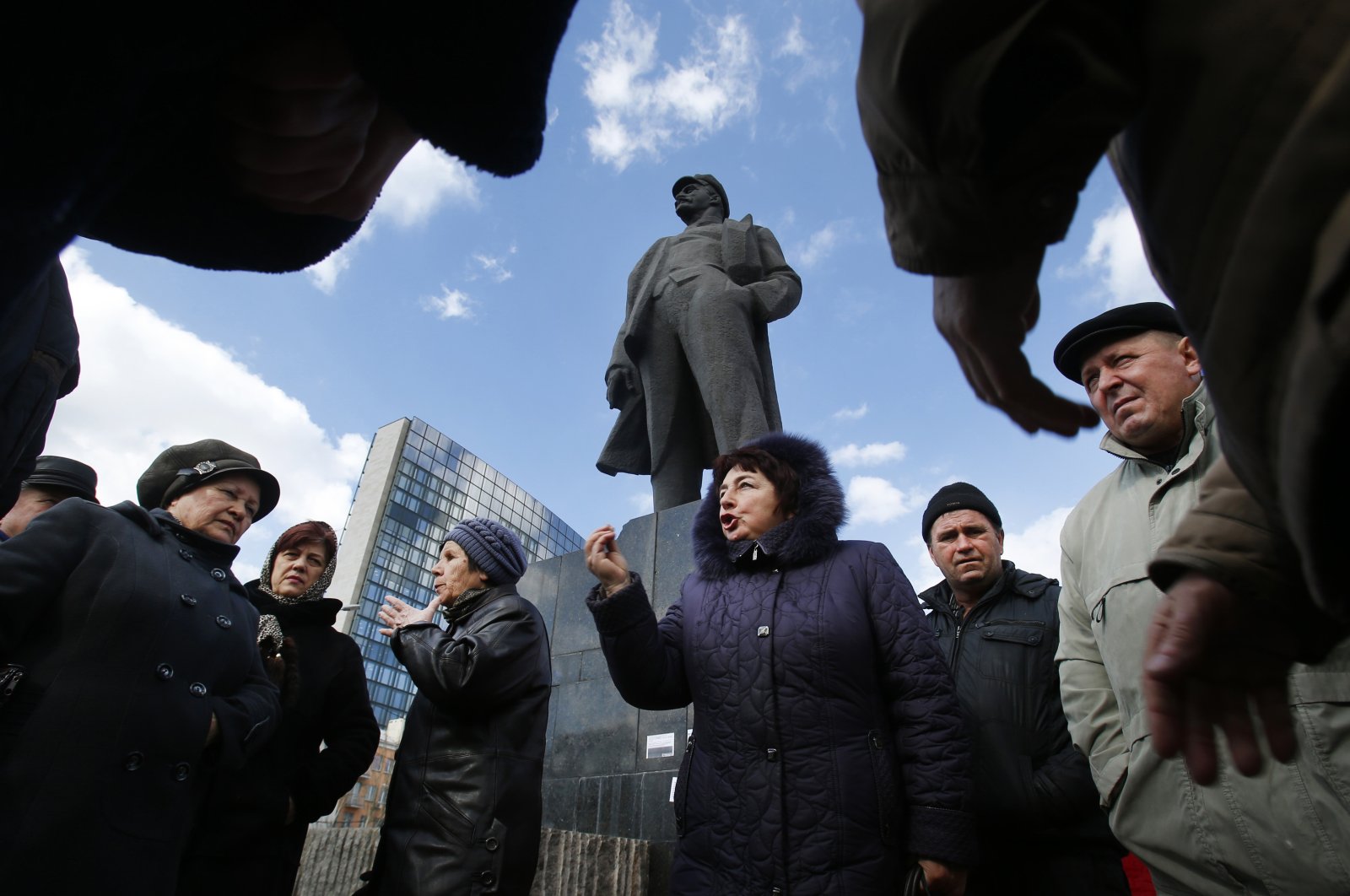 People talk about developments in Ukraine at a central square next to a statue of Soviet revolutionary leader Vladimir Lenin in Donetsk, Ukraine, March 12, 2014. (AP Photo)