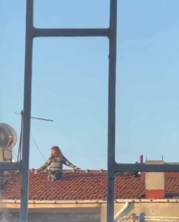 A young woman doing yoga on a multistory apartment rooftop, Kadıköy, Istanbul, Feb. 22, 2022. (IHA Photo)