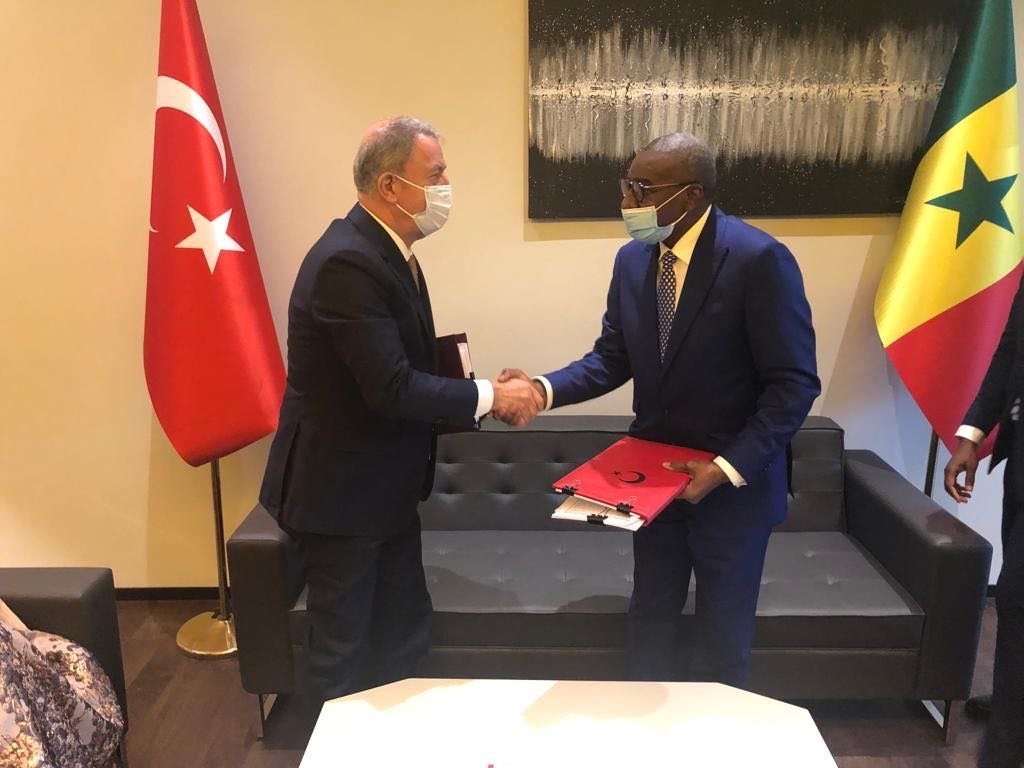 Defense Minister Hulusi Akar shakes hands with Senegalese counterpart Sidiki Kaba after signing joint agreement, Feb. 22, 2022.