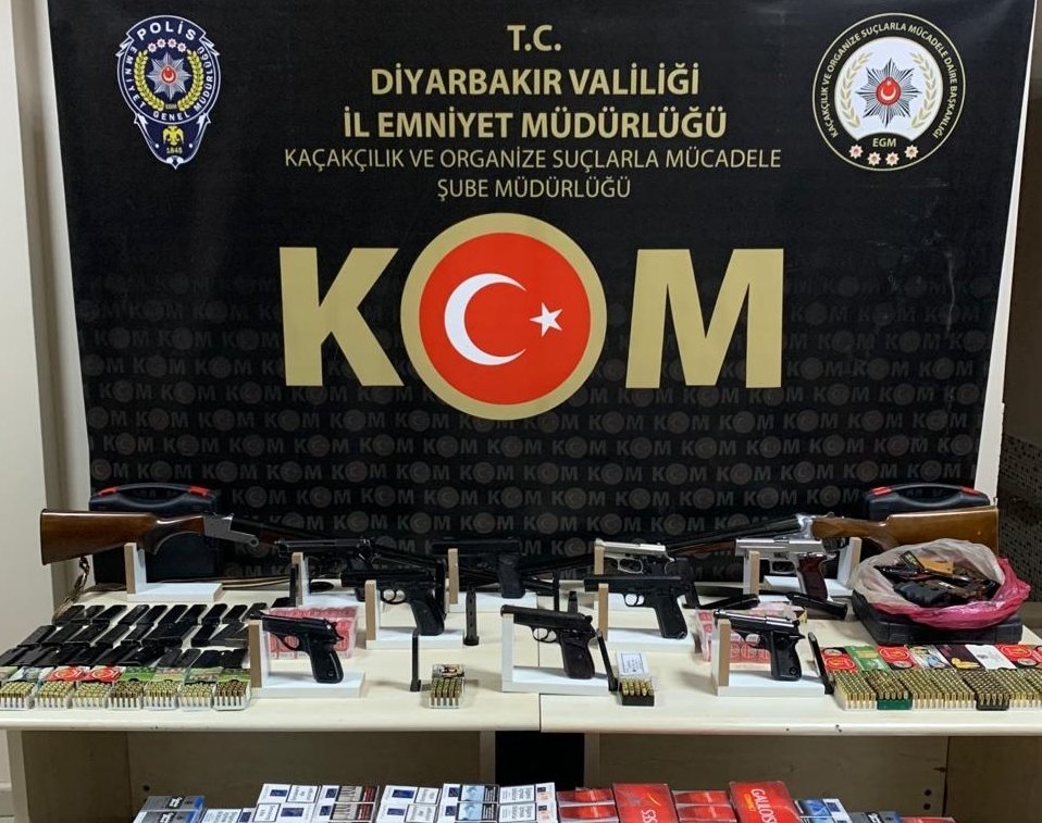 Guns and cigarettes seized by the police are put on display in eastern Diyarbakır province, Turkey, Feb. 23, 2021. (AA Photo)