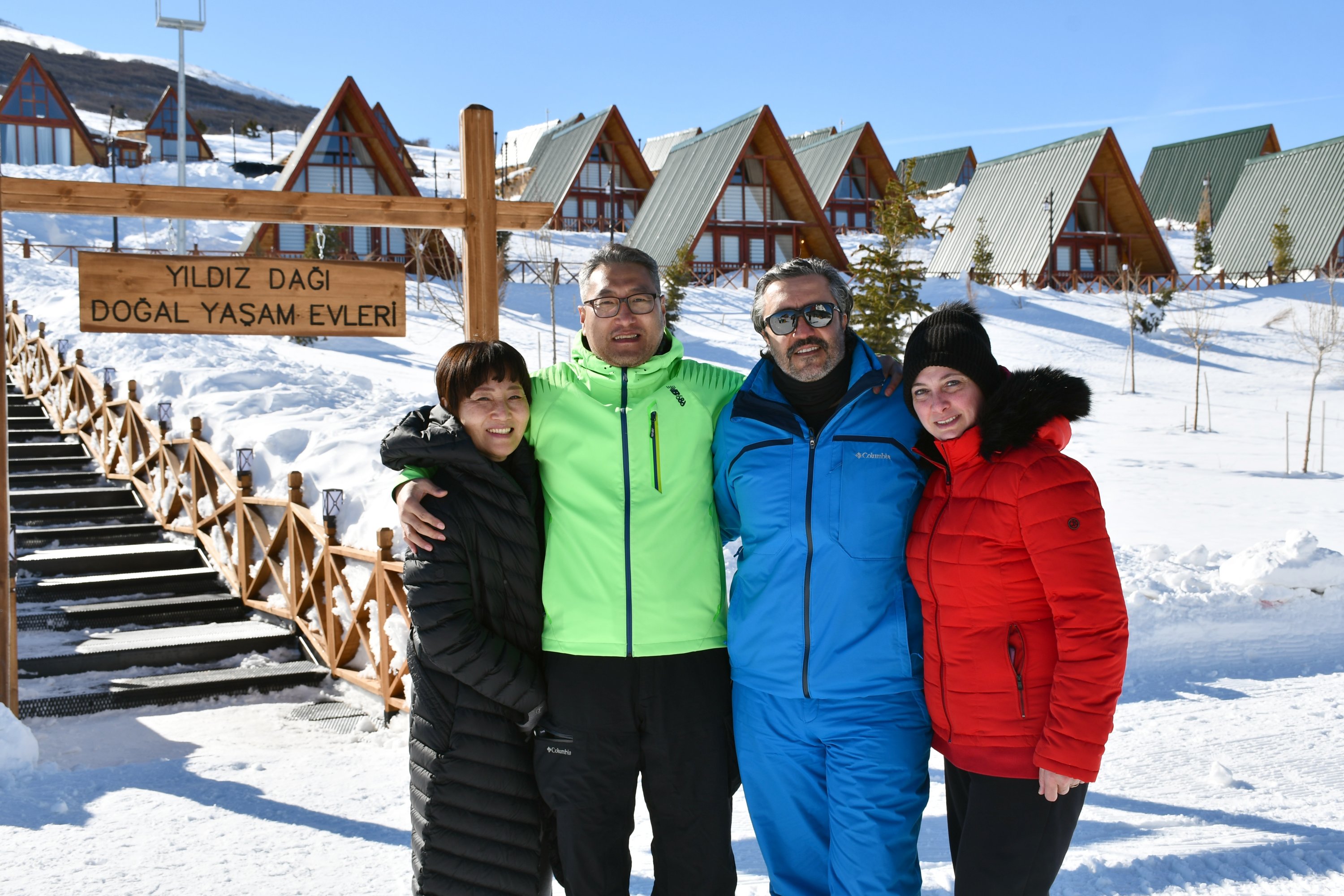 South Korean guest Back Myoungsu and his family outside the self-contained bungalows at the Yıldız Mountain Winter Sports and Tourism Center, Sivas, central Turkey, Feb. 22, 2022. (AA Photo)