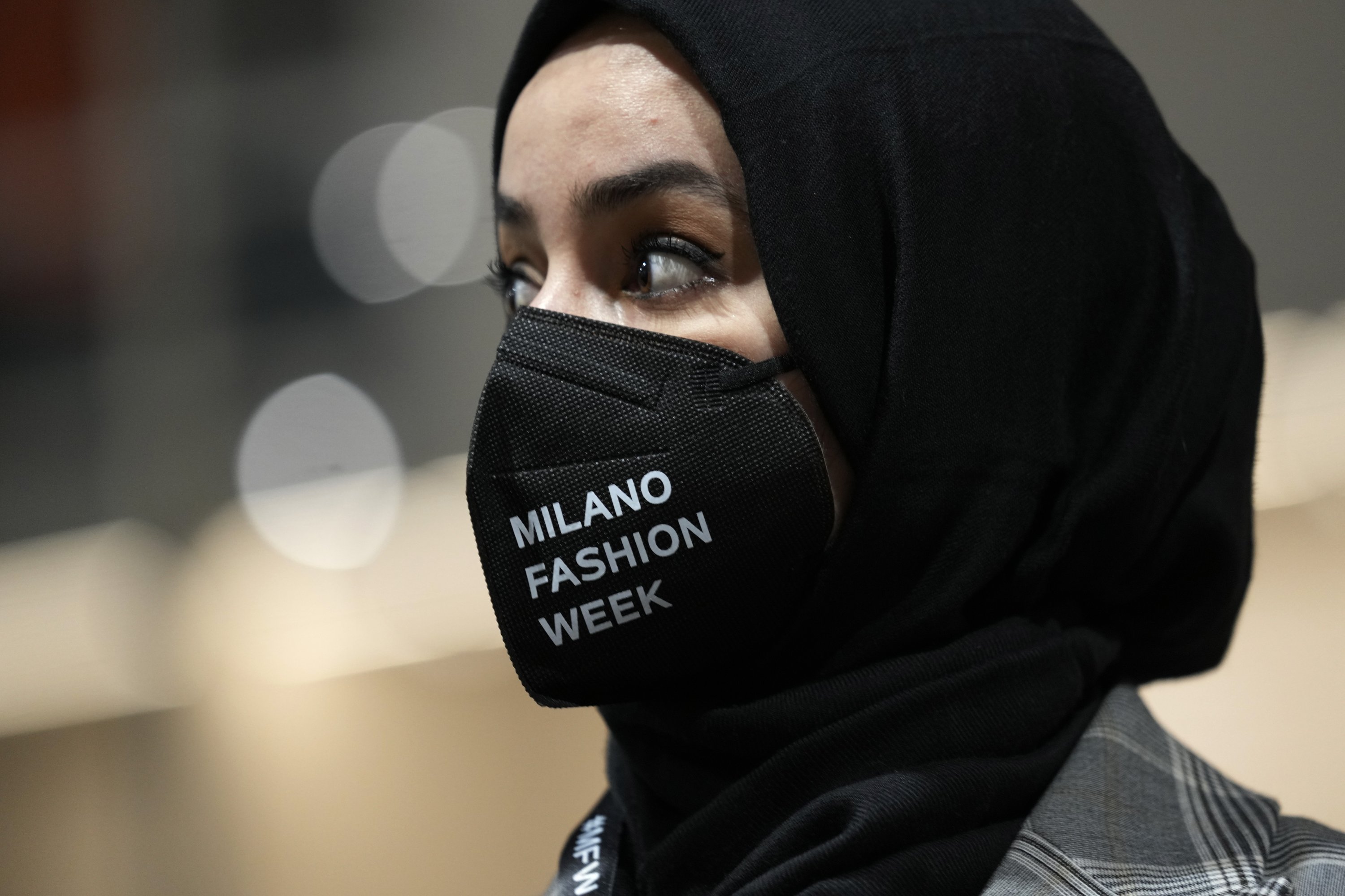 Fashion designer Zineb Hazim, from Morocco, stands next to her creations as part of the We Are Made in Italy Spring Summer 2022 collective fashion event, unveiled during the Milan Fashion Week, Italy, Feb. 22, 2022. (AP Photo)