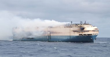 The ship, Felicity Ace, which was traveling from Emden, Germany, where Volkswagen has a factory, to Davisville, in the U.S. state of Rhode Island, burns more than 100 km from the Azores islands, Portugal, Feb. 18, 2022. (Portuguese Navy Handout via Reuters)