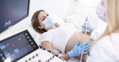 Ultrasound pregnancy examination of young woman in a medical clinic during a COVID-19 outbreak. (Getty Images)