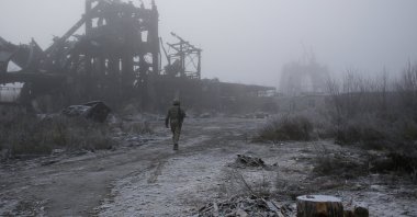 Ukrainian soldier passes by a destroyed Butovka coal mine as he approaches his front line position in the town of Avdiivka in the Donetsk region, Ukraine, Nov. 19, 2019. (AP Photo)
