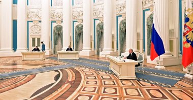 Russian President Vladimir Putin (R) attends a ceremony to sign documents, including a decree recognising two Russian-backed breakaway regions in eastern Ukraine as independent, with the leaders of the self-proclaimed republics Leonid Pasechnik (L) and Denis Pushilin (C) during a ceremony at the Kremlin in Moscow, Russia, Feb. 21, 2022. (AFP Photo)