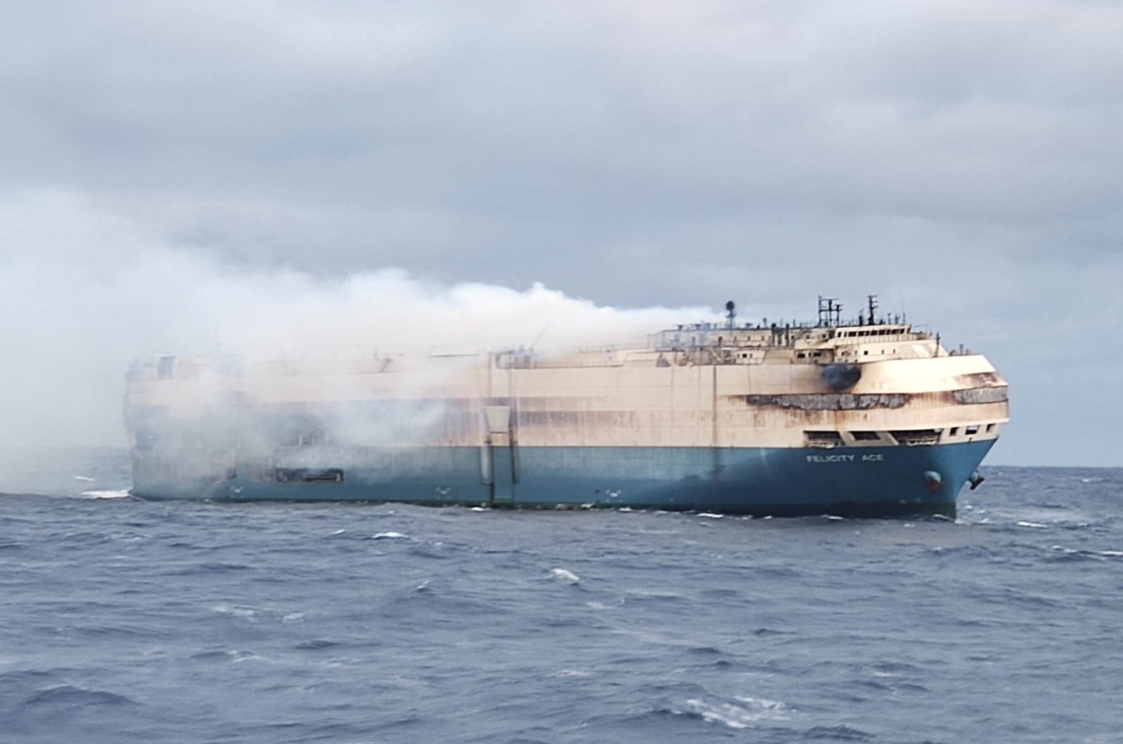 The ship, Felicity Ace, which was traveling from Emden, Germany, where Volkswagen has a factory, to Davisville, in the U.S. state of Rhode Island, burns more than 100 km from the Azores islands, Portugal, Feb. 18, 2022. (Portuguese Navy Handout via Reuters)