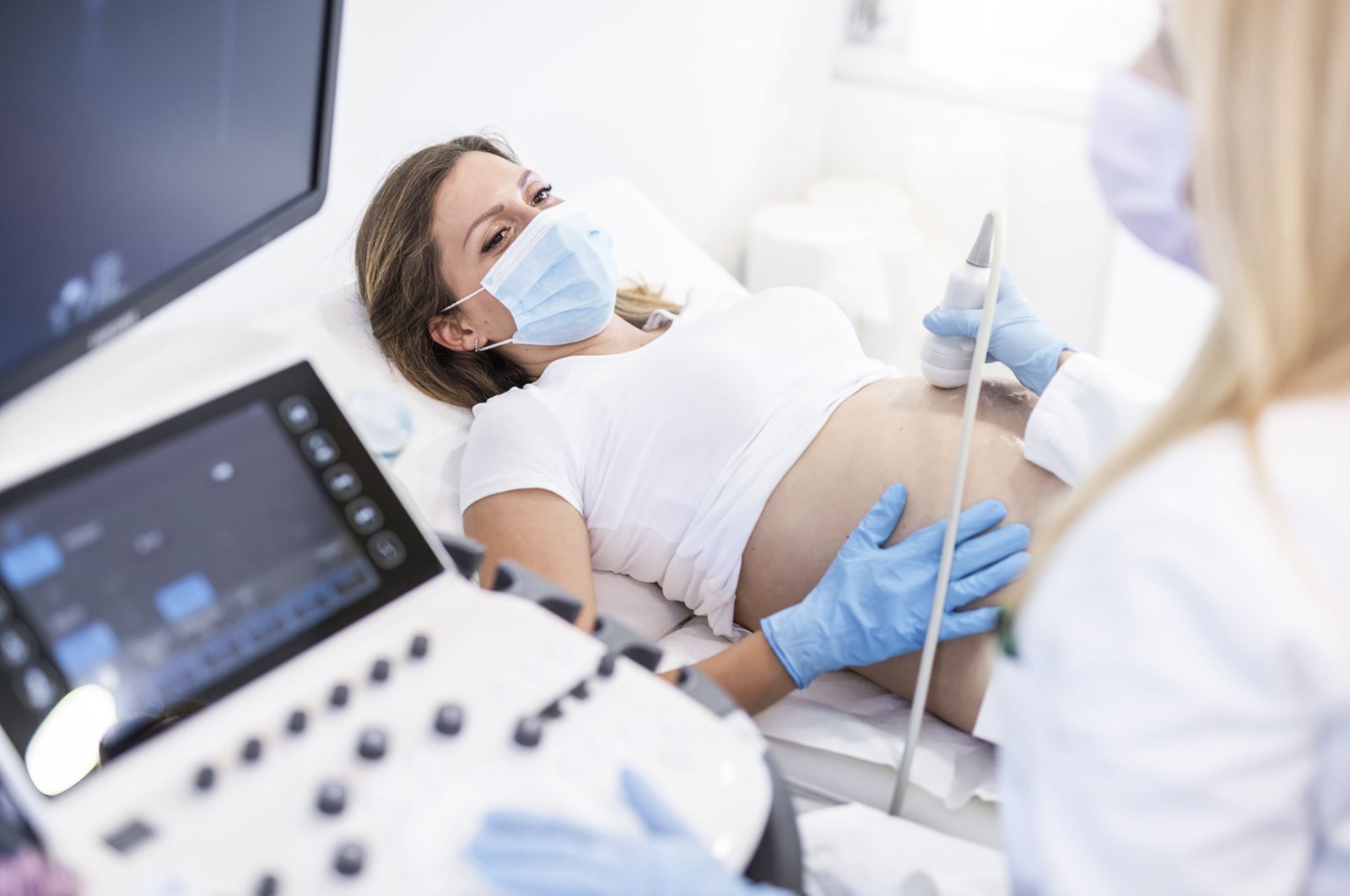 Ultrasound pregnancy examination of young woman in a medical clinic during a COVID-19 outbreak. (Getty Images)