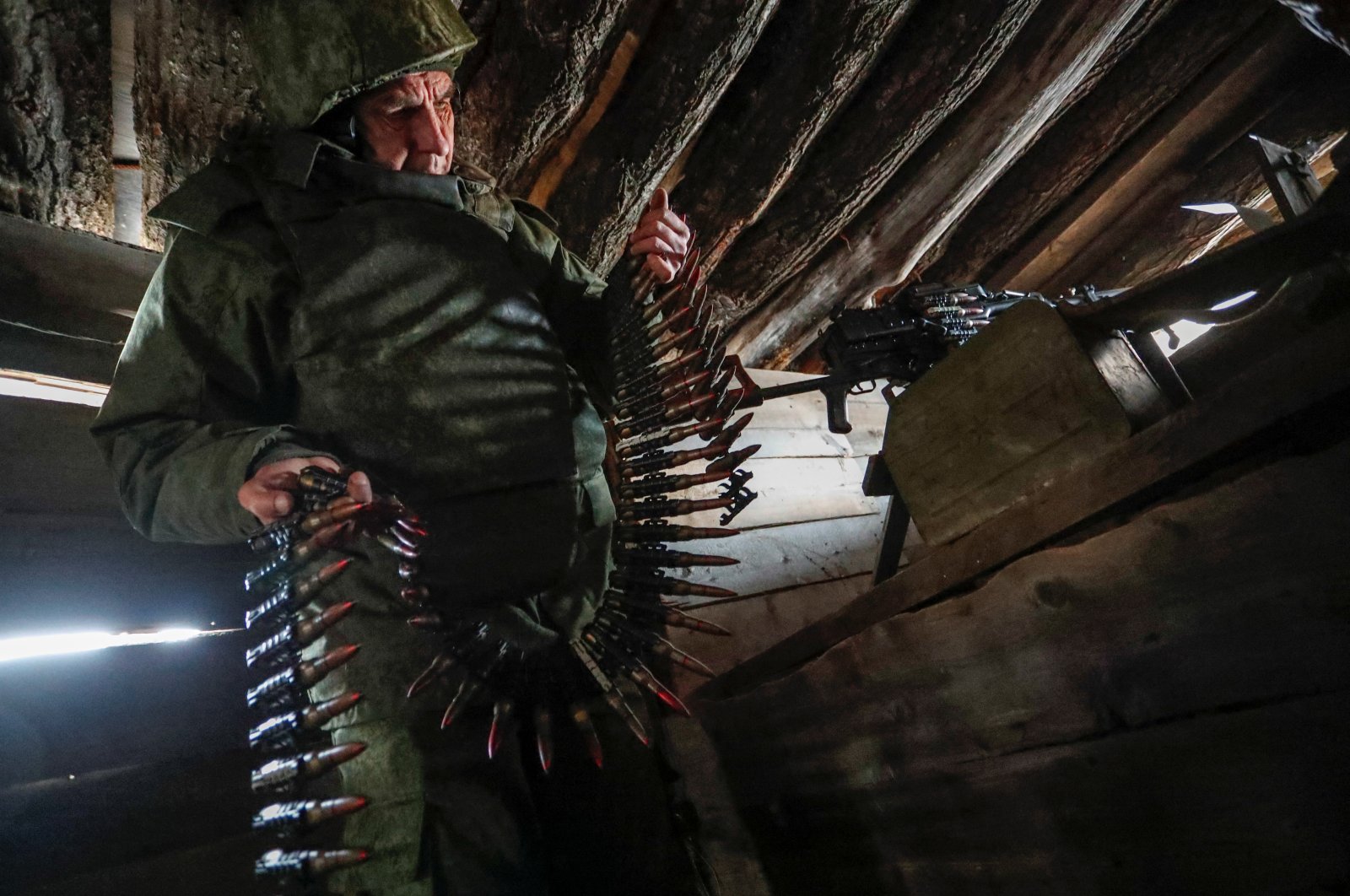 A militant of the self-proclaimed Luhansk People&#039;s Republic holds a bullet belt at combat positions near the line of separation from the Ukrainian armed forces outside the settlement of Molodizhne (Molodezhnoye) in the Luhansk region, Ukraine, Feb. 17, 2022. (Reuters Photo)