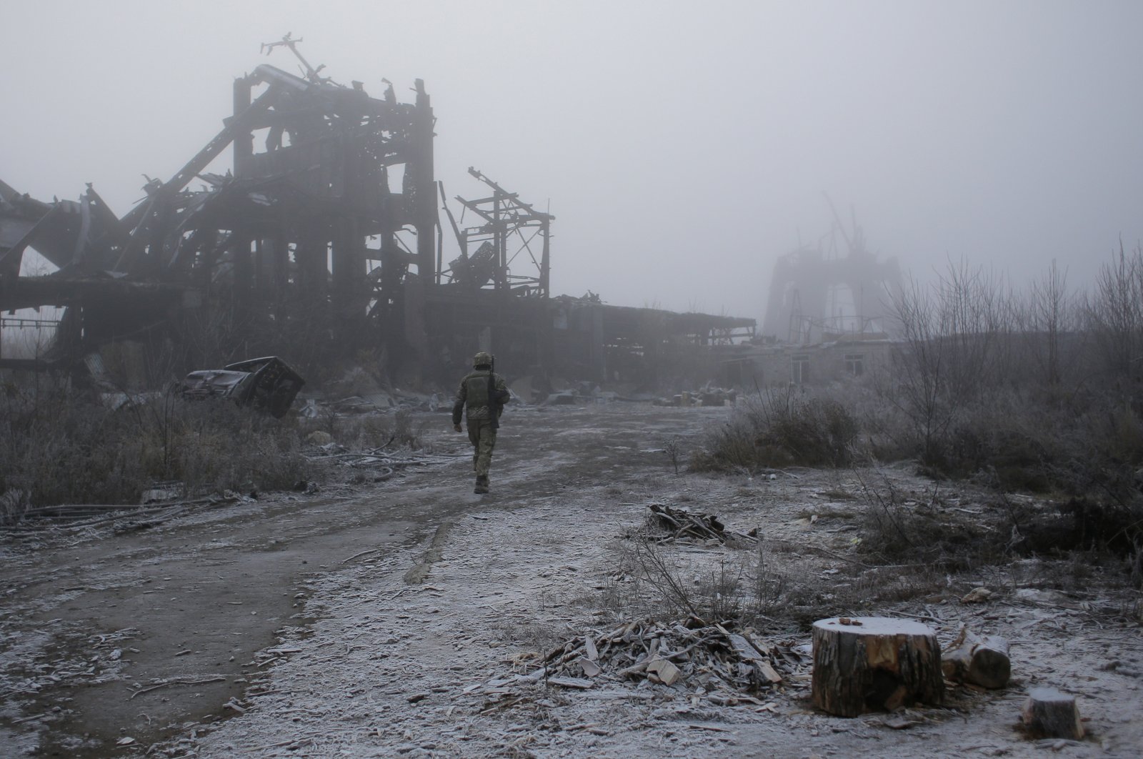 Ukrainian soldier passes by a destroyed Butovka coal mine as he approaches his front line position in the town of Avdiivka in the Donetsk region, Ukraine, Nov. 19, 2019. (AP Photo)