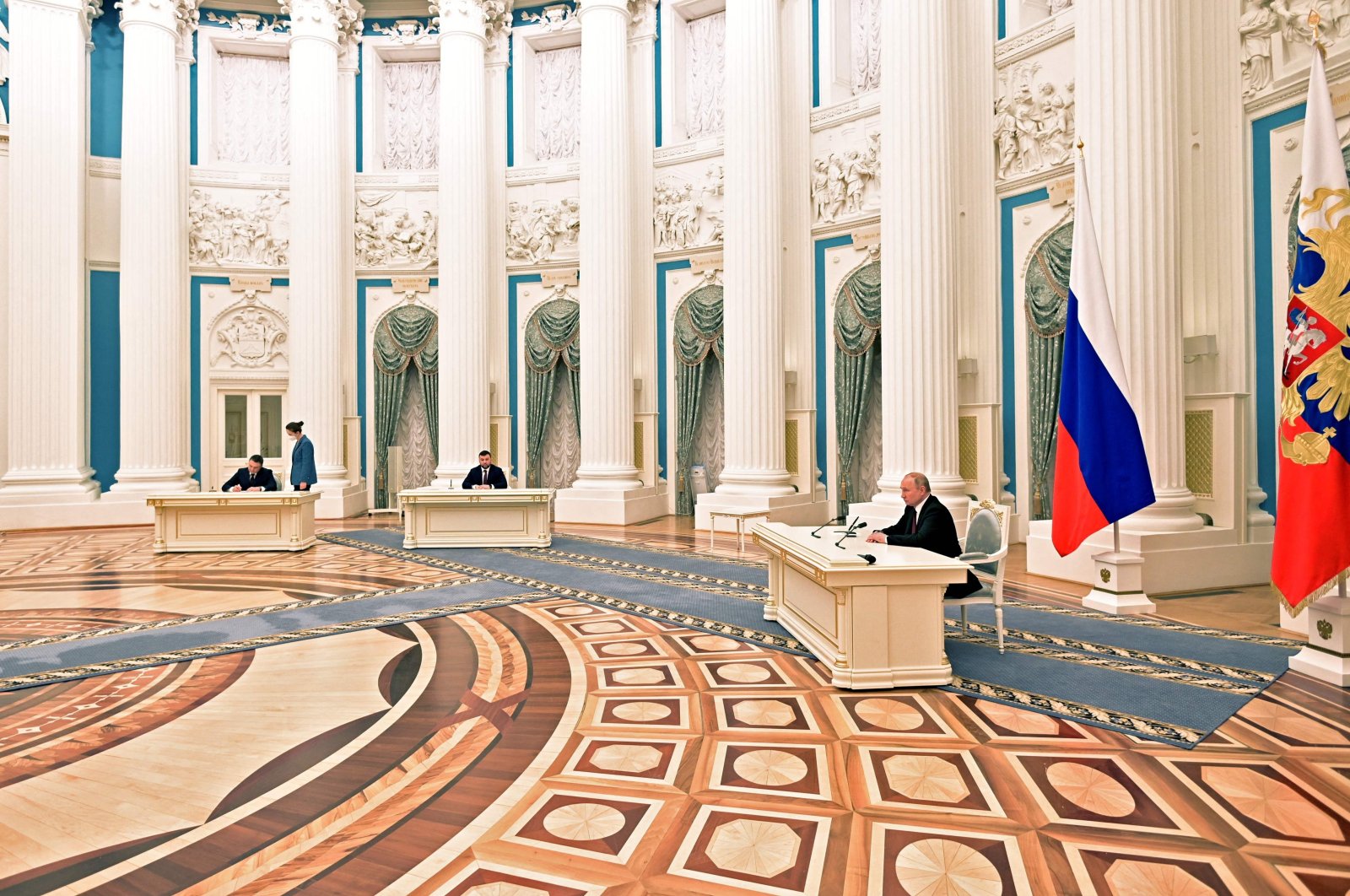 Russian President Vladimir Putin (R) attends a ceremony to sign documents, including a decree recognising two Russian-backed breakaway regions in eastern Ukraine as independent, with the leaders of the self-proclaimed republics Leonid Pasechnik (L) and Denis Pushilin (C) during a ceremony at the Kremlin in Moscow, Russia, Feb. 21, 2022. (AFP Photo)