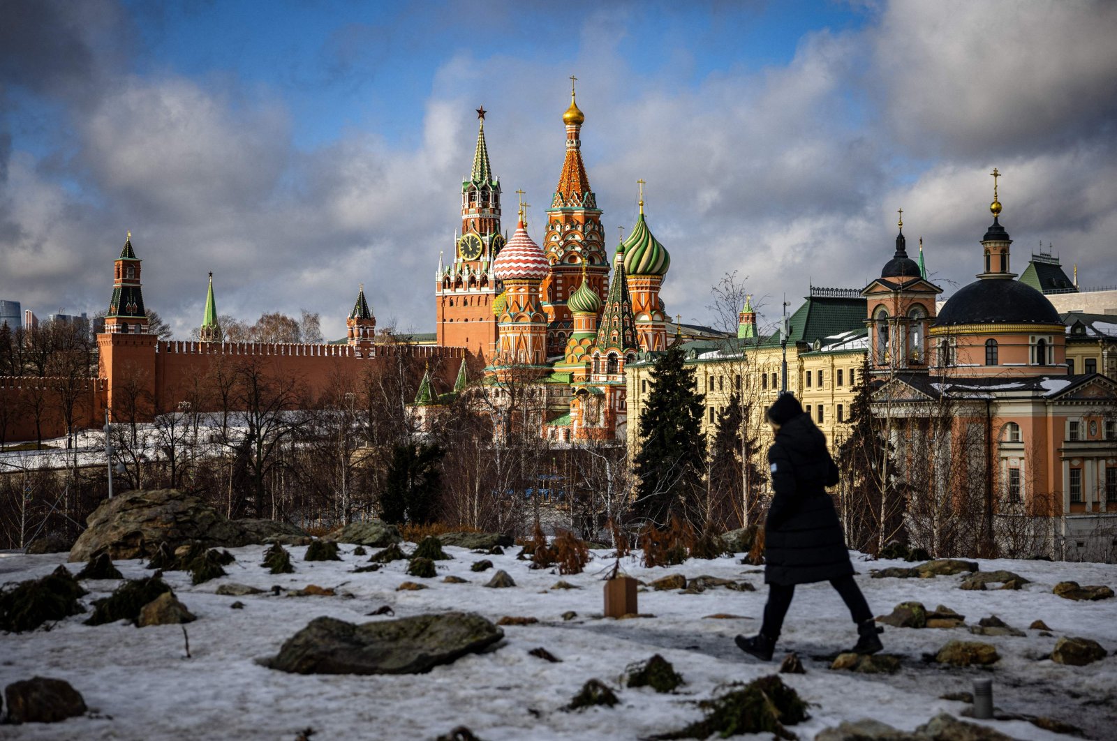 A person walks in Zaryadye park in front of the Kremlin and St. Basil&#039;s Cathedral in central Moscow on Feb. 22, 2022. (AFP Photo)