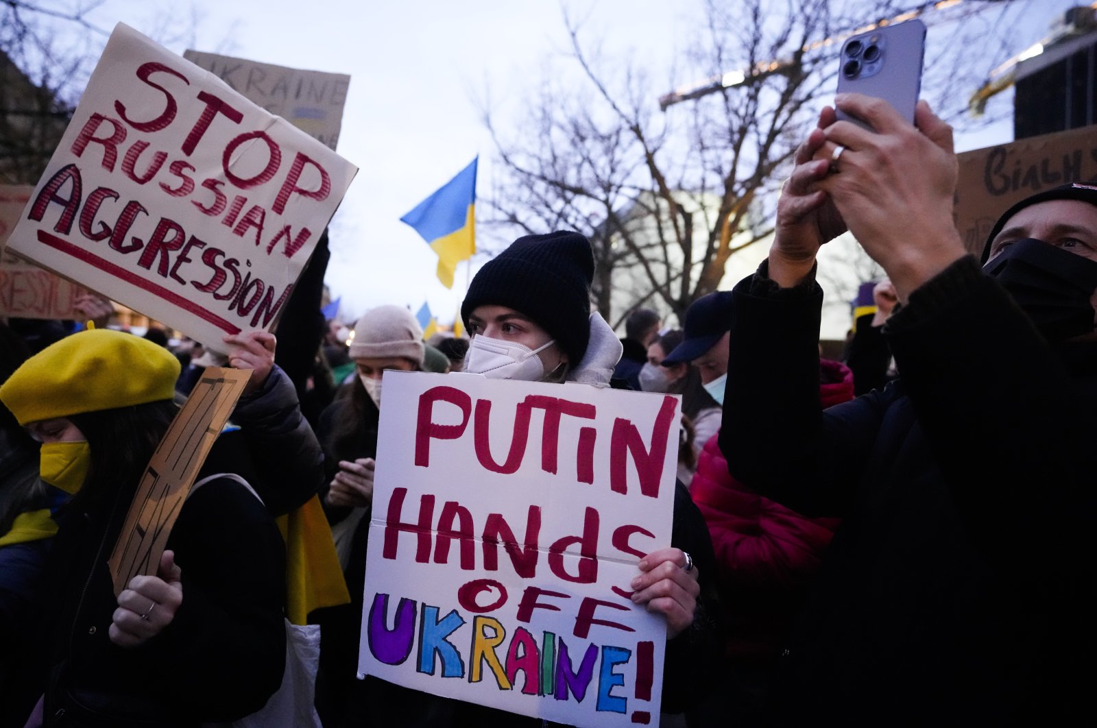Women show posters in support of Ukraine as they attend a demonstration along the street near the Russian embassy to protest against the escalation of the tension between Russia and Ukraine in Berlin, Germany, Feb. 22, 2022. (AP Photo)