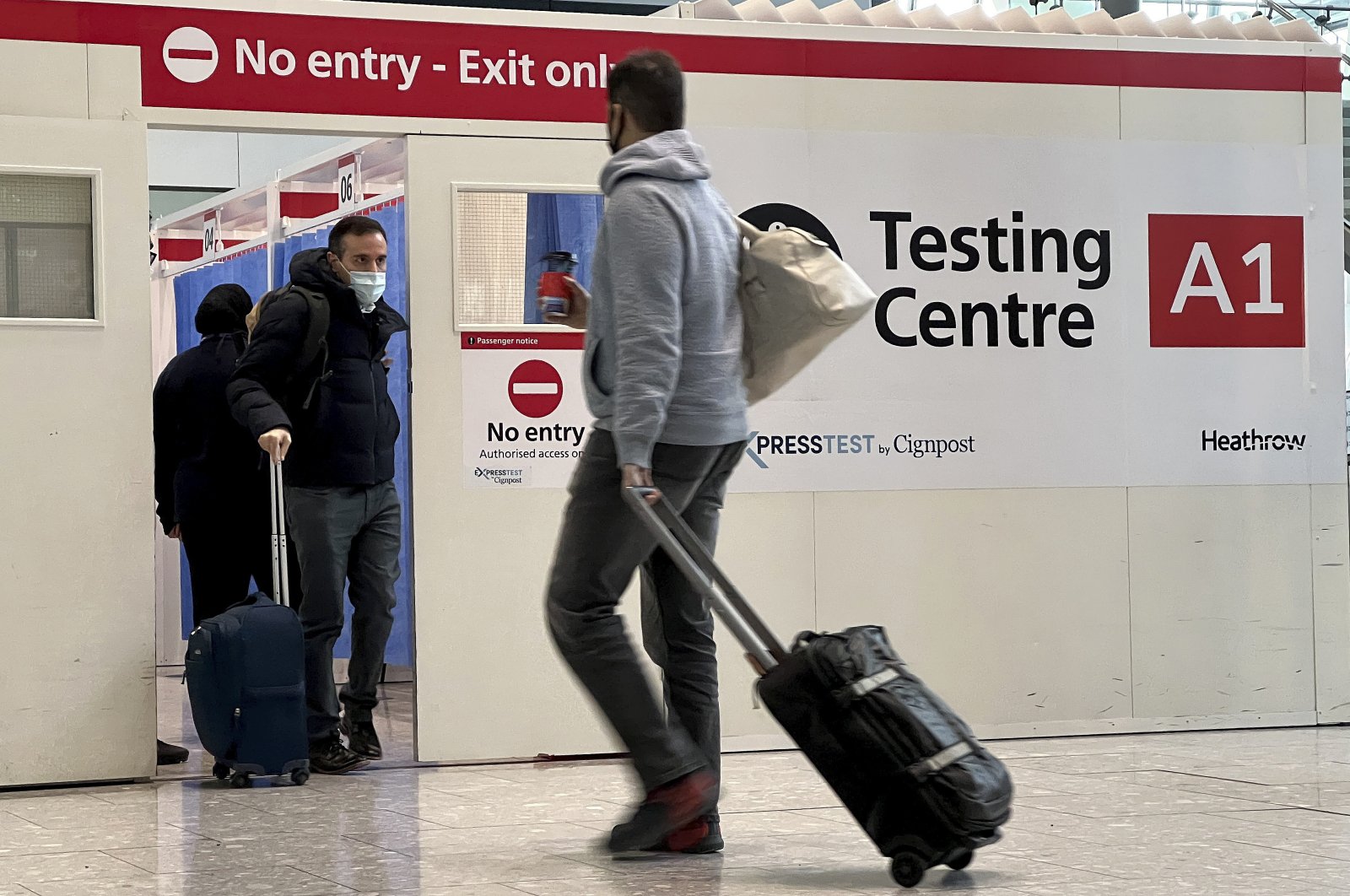 Passengers get a COVID-19 test at Heathrow Airport in London, UK, Nov. 29, 2021. (AP Photo)