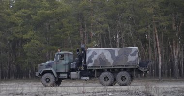 A military vehicle stands by the side of a road in Sievierodonetsk, Luhansk region, eastern Ukraine, Thursday, Feb. 24, 2022. (AP Photo)
