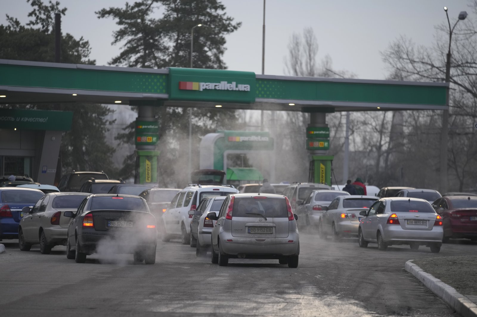 People queue for fuel at a gas station in Sievierodonetsk, Luhansk region, eastern Ukraine, Thursday, Feb. 24, 2022. (AP Photo)