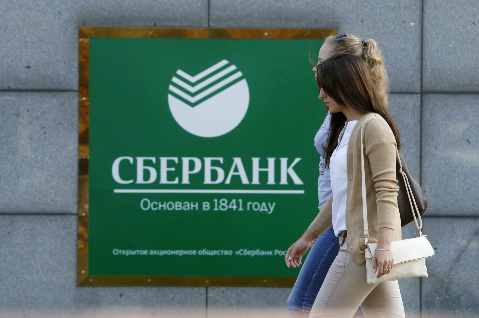Women walk past an office of Sberbank in Moscow, Russia, Sept. 12, 2014. (Reuters Photo)