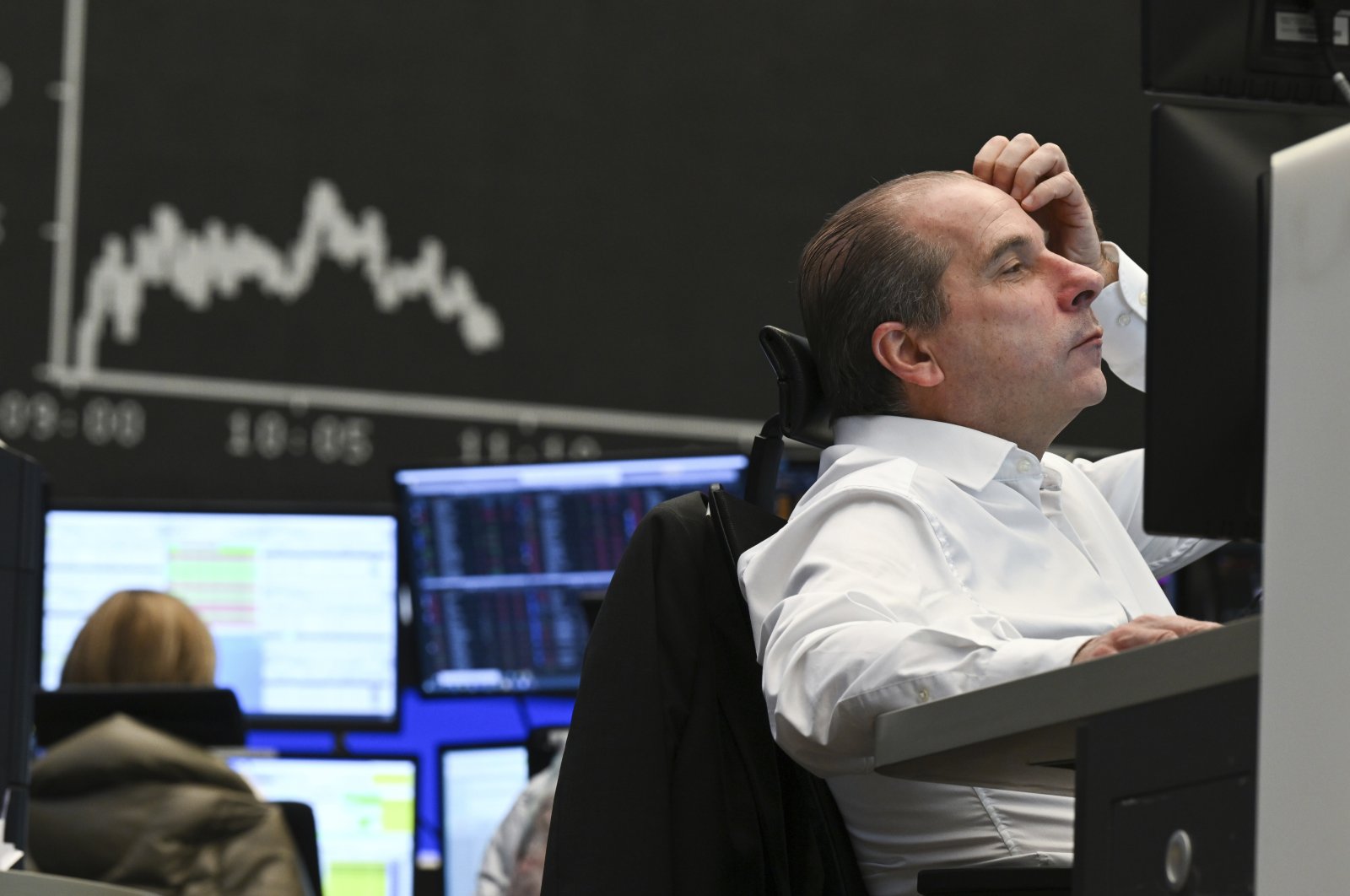 A stock trader watches his monitor on the floor of the Frankfurt Stock Exchange in Frankfurt, Germany, Feb. 24, 2022. (AP Photo)