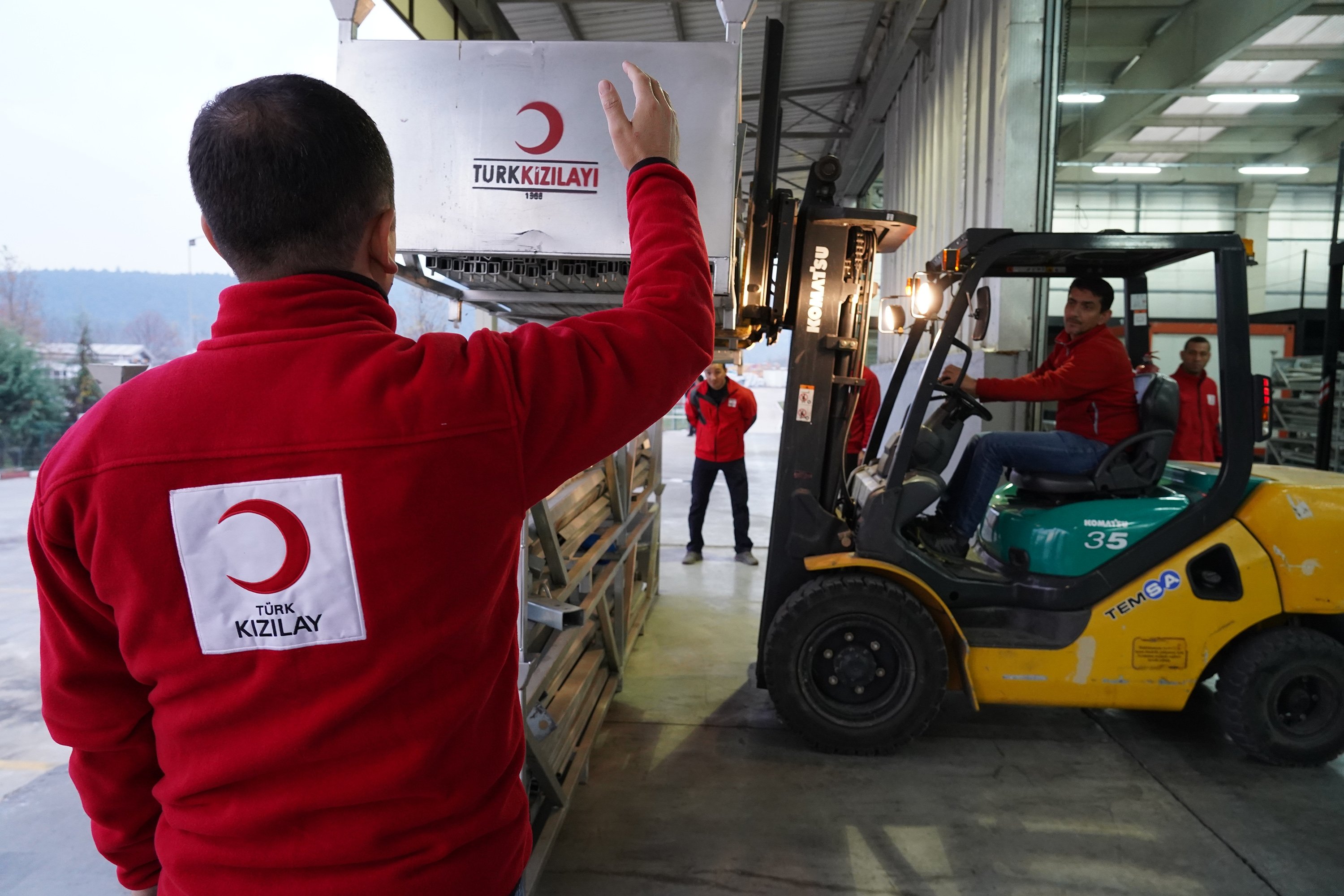 Turkish Red Crescent workers loading humanitarian aid on trucks, Turkey, Feb. 25, 2022. (AA PHOTO)