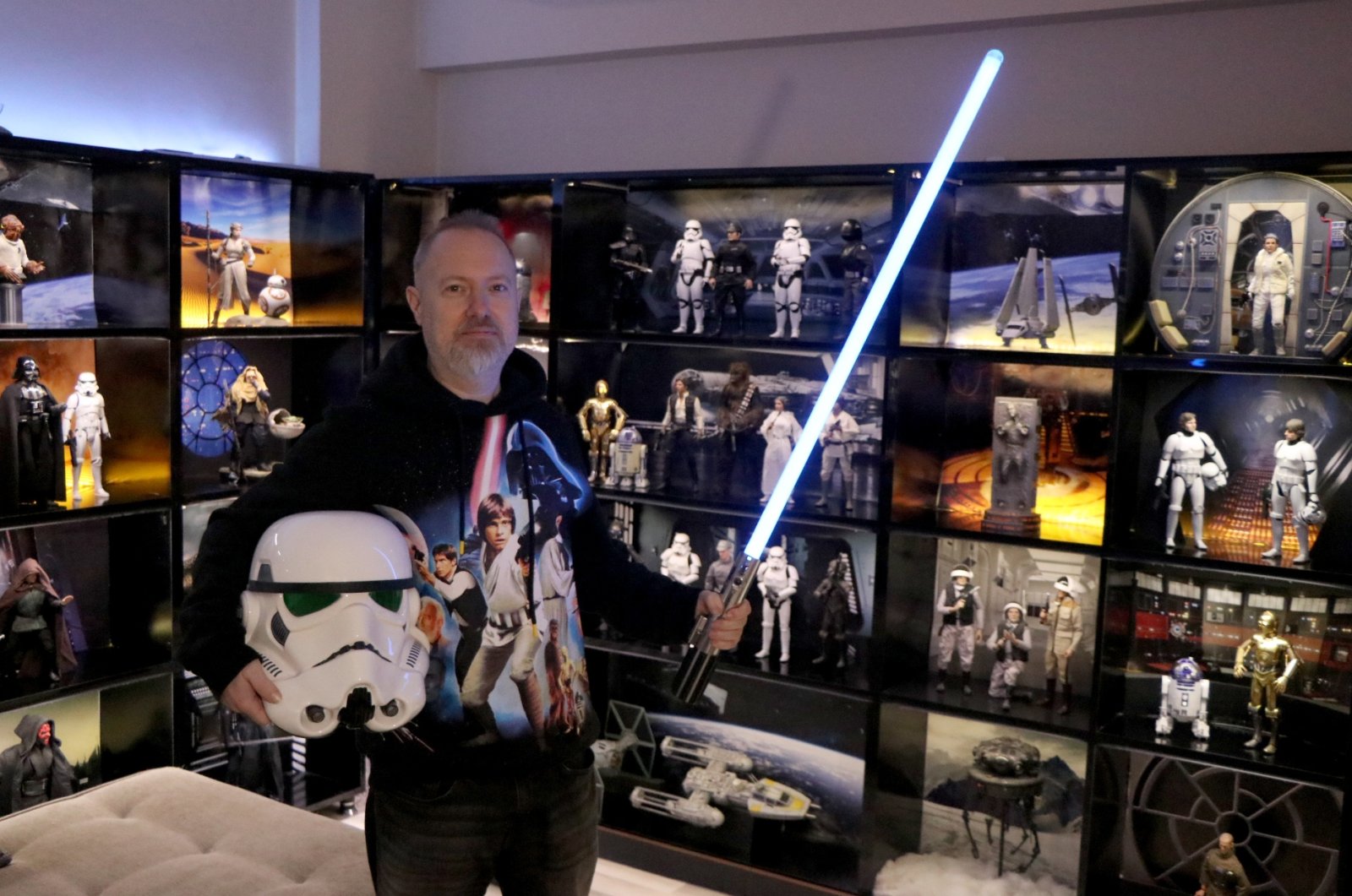 Cihat Uygun poses with the pieces of his collection exhibited in the "Star Wars" museum in his living room, Edirne, Turkey, Feb. 24, 2022. (DHA PHOTO)