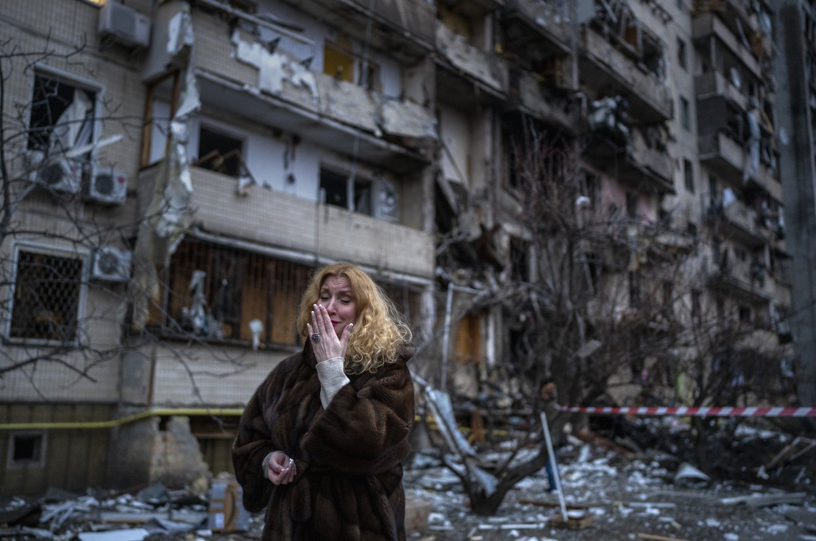 Natali Sevriukova reacts next to her house following a rocket attack the city of Kyiv, Ukraine, Friday, Feb. 25, 2022. (AP Photo)