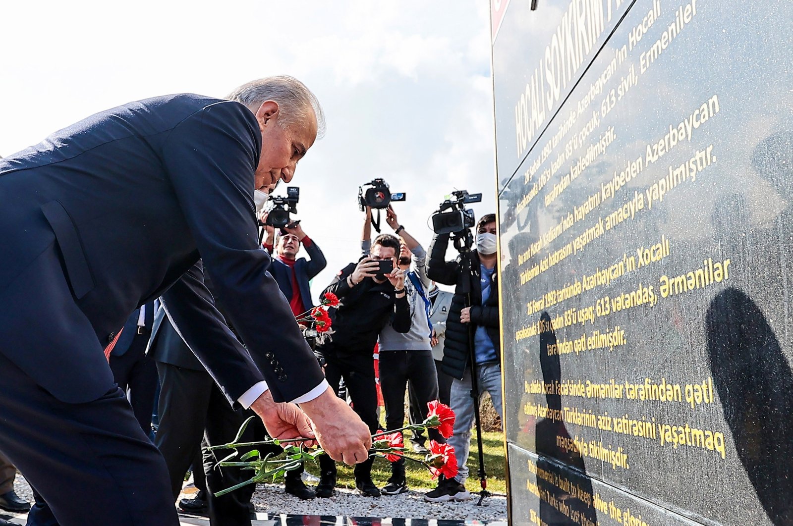 Azerbaijan&#039;s ambassador to Turkey, Rashad Mammadov, leaves carnations on the granite memorial of the Khojaly massacre, Ankara, Turkey, Feb. 24, 2022. (IHA Photo)