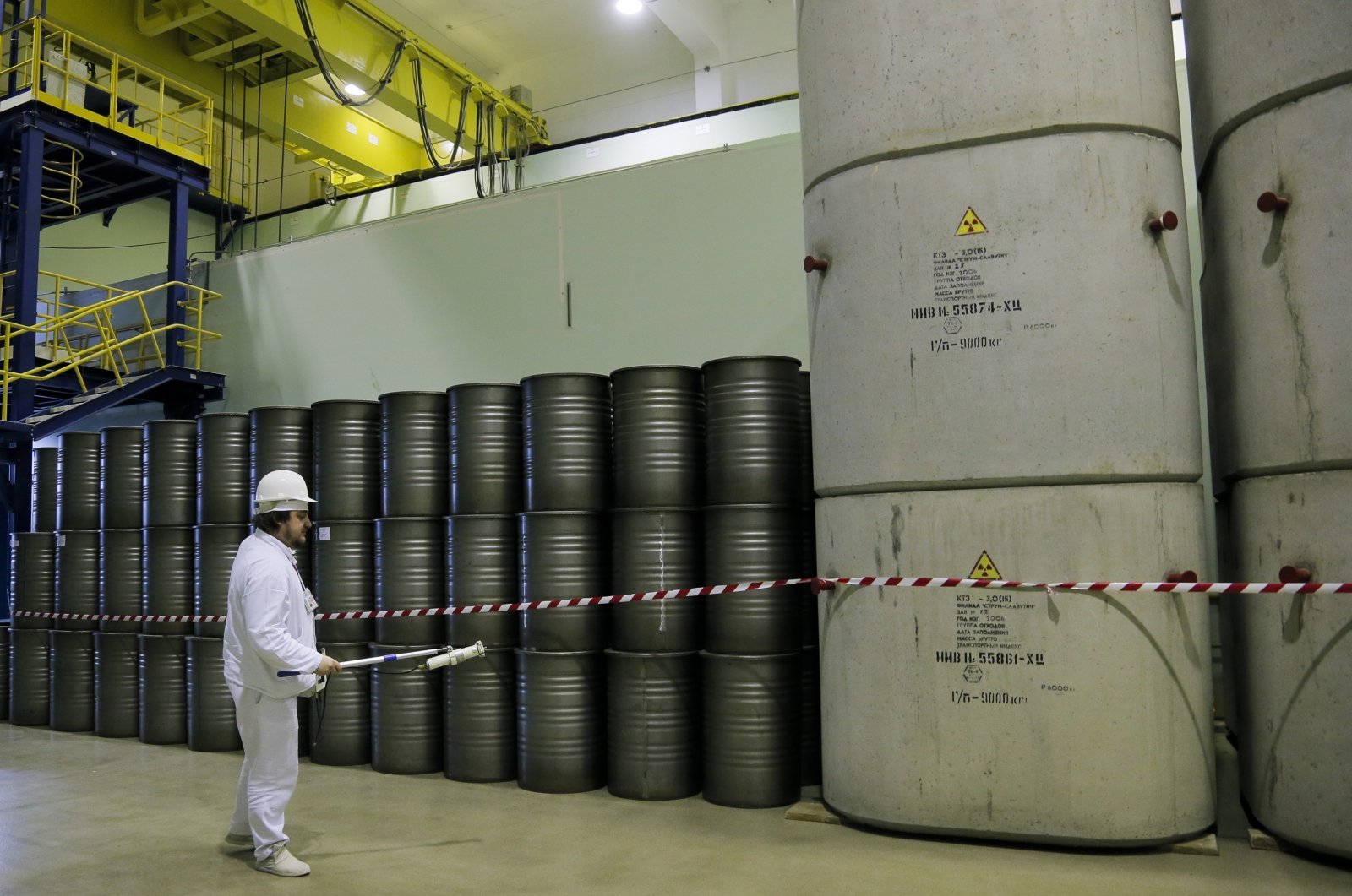 A worker checks the radiation level of barrels of nuclear waste from the Chernobyl nuclear power plant in Chernobyl, Ukraine, March 23, 2016. (AP Photo)